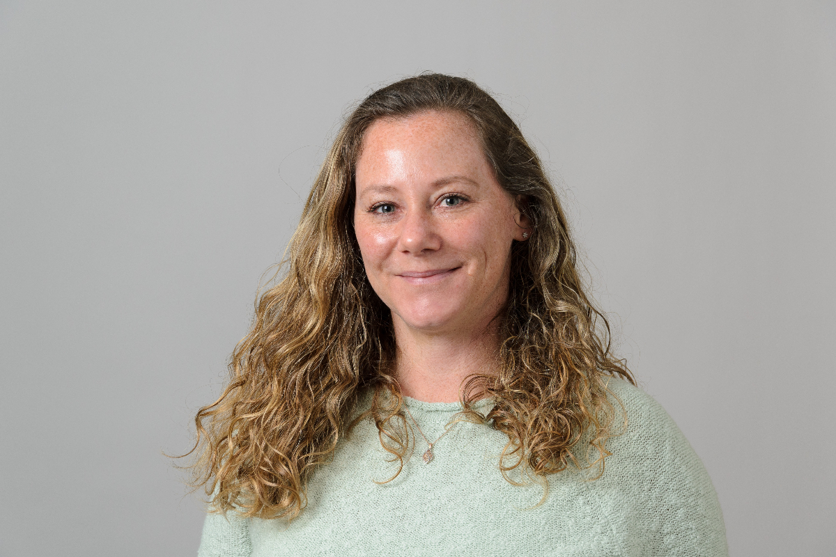 Jill Reinhard, Grant Manager, smiling and wearing a green sweater.
