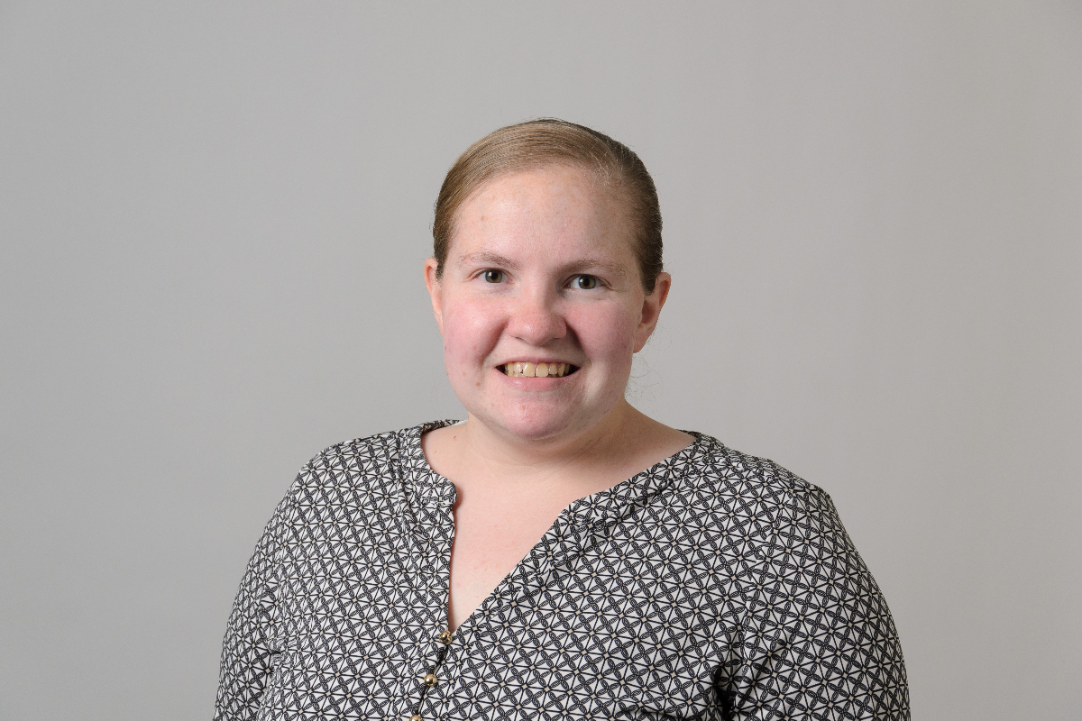Sarah Virkler, Business Operations Specialist I, smiling with a black and white shirt.